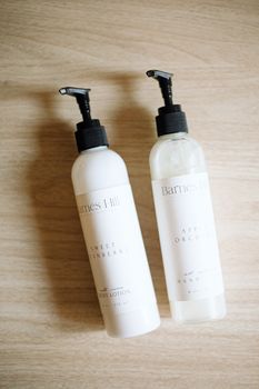 Flatlay of Barnes Hill skincare products with minimalist packaging on wooden background.