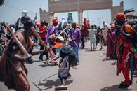 Energetic traditional dance at a lively outdoor cultural festival.