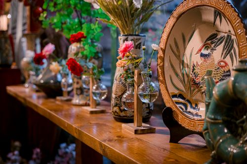 Free Colorful ceramic vases and a decorative platter on a wooden table creating an artistic atmosphere. Stock Photo