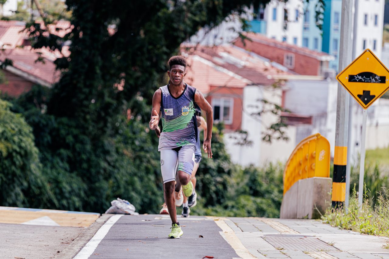 athletic man running on urban street pathway focused on exercise amids