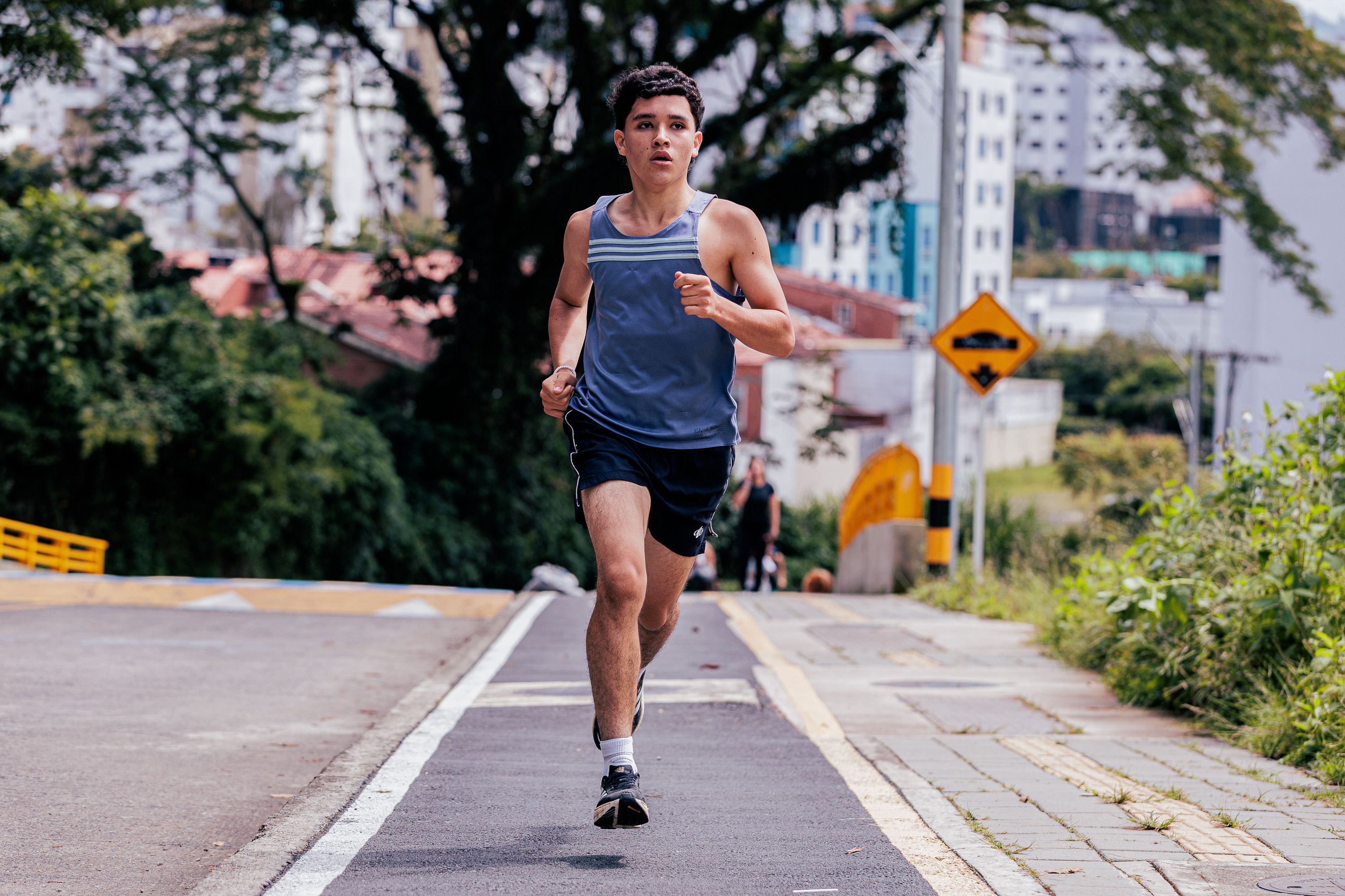 Young Man Running on City Street in Summer · Free Stock Photo