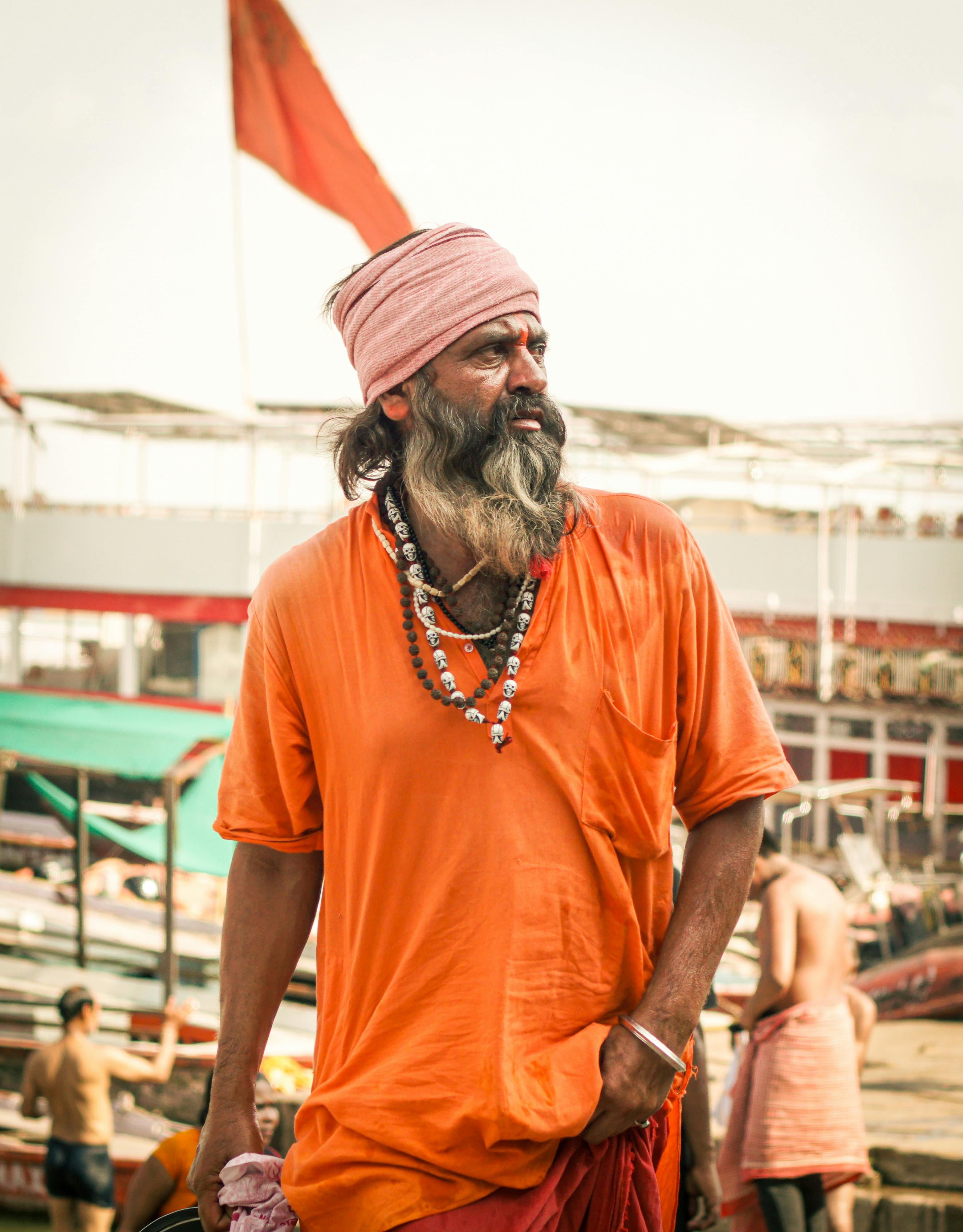 Free A spiritual Sadhu in traditional attire stands at the Varanasi Ghats in India. Stock Photo