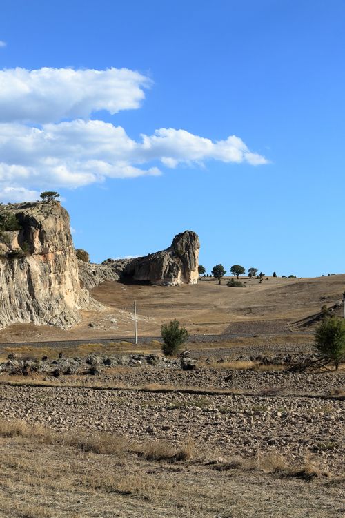 Free A captivating rocky landscape with clear blue sky and sparse trees. Stock Photo