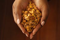 Hands Holding Crunchy Corn Snacks