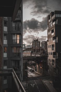 Dramatic urban street scene of Southwark, London during winter twilight with cloudy skies.