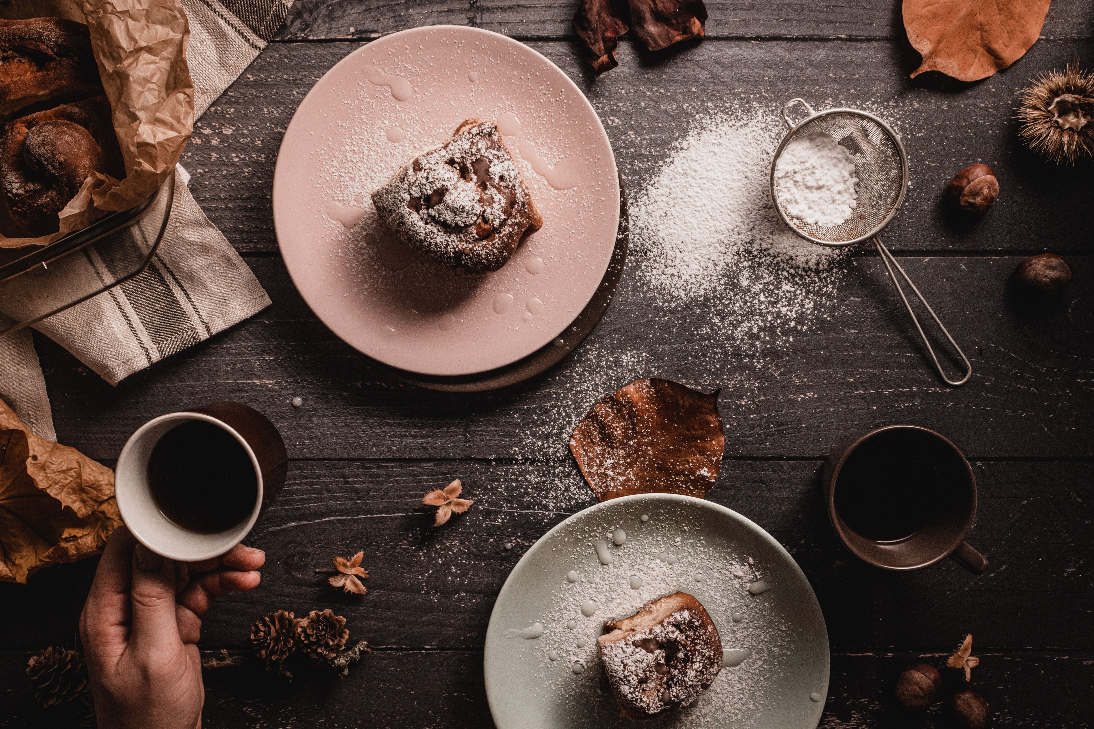 where to buy gourmet flavored coffee - Cozy autumn scene with pastries, coffee, and rustic decor on a wooden table.