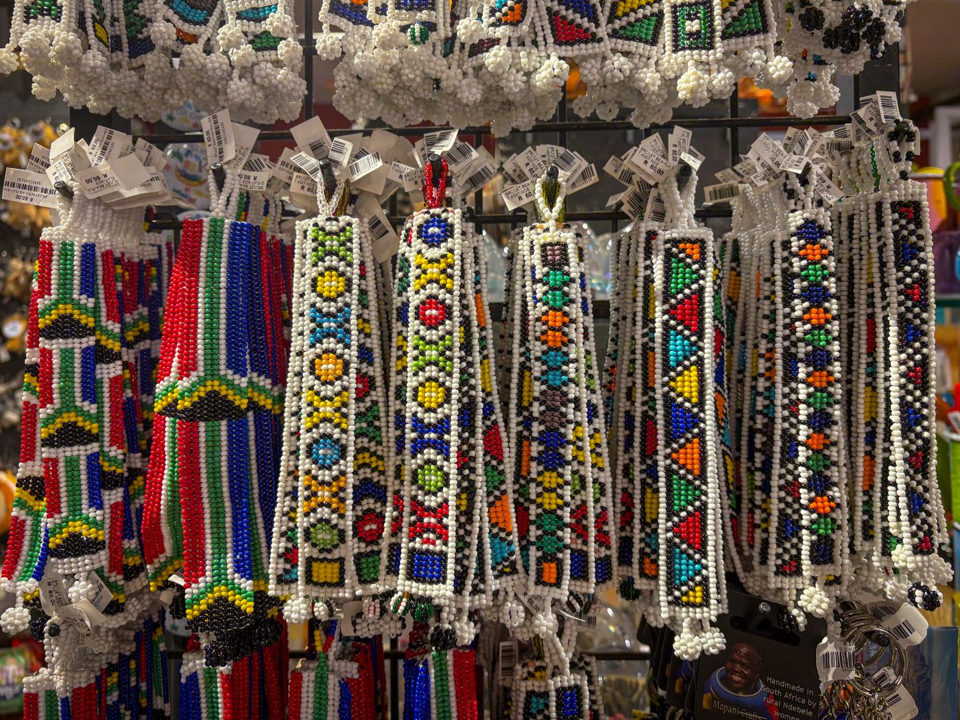 Beaded Kenyan crafts hanging in a market stall