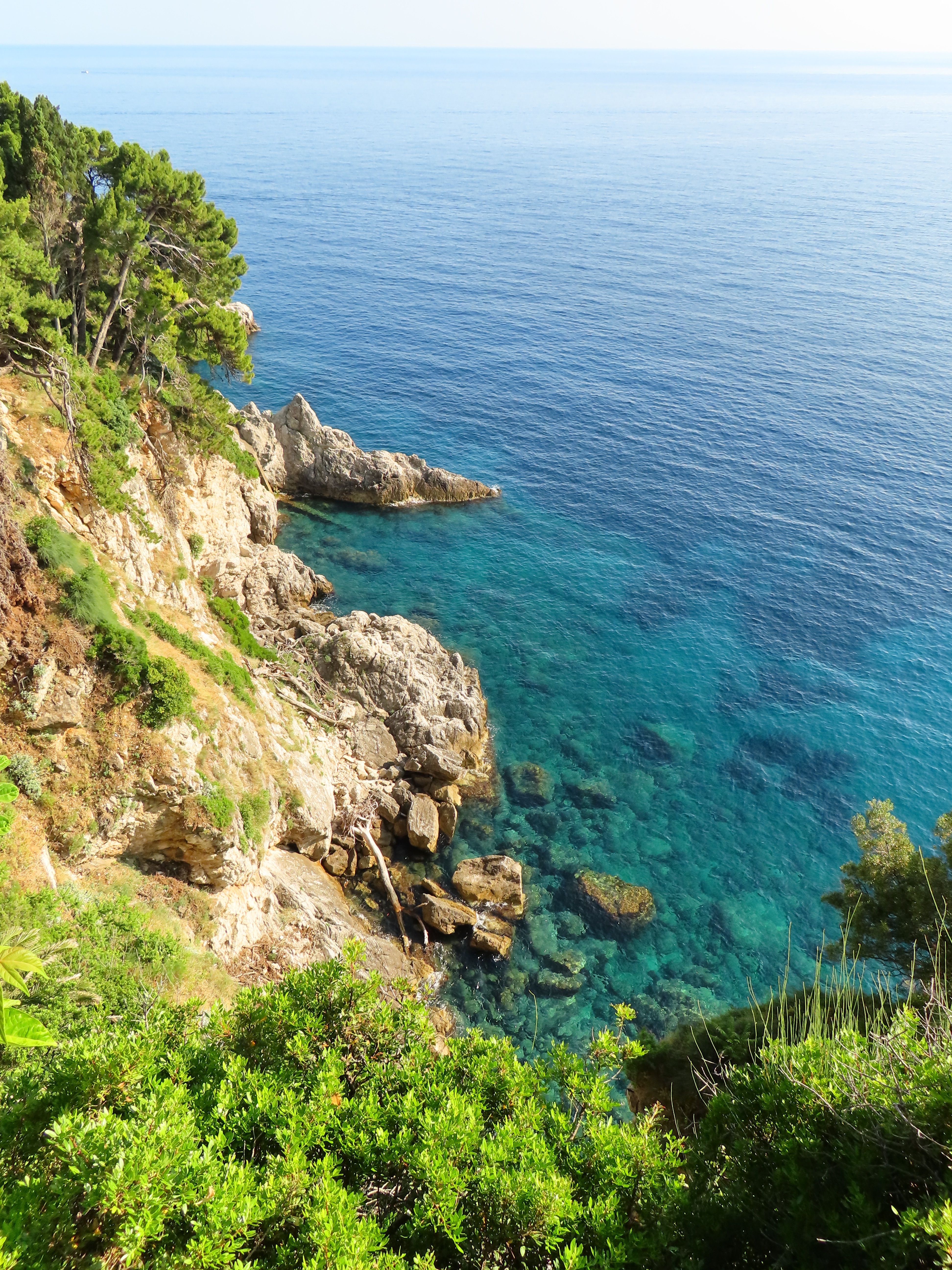 Scenic Coastal Cliff with Crystal Clear Waters · Free Stock Photo