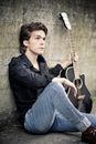 Man Sitting Holding Guitar