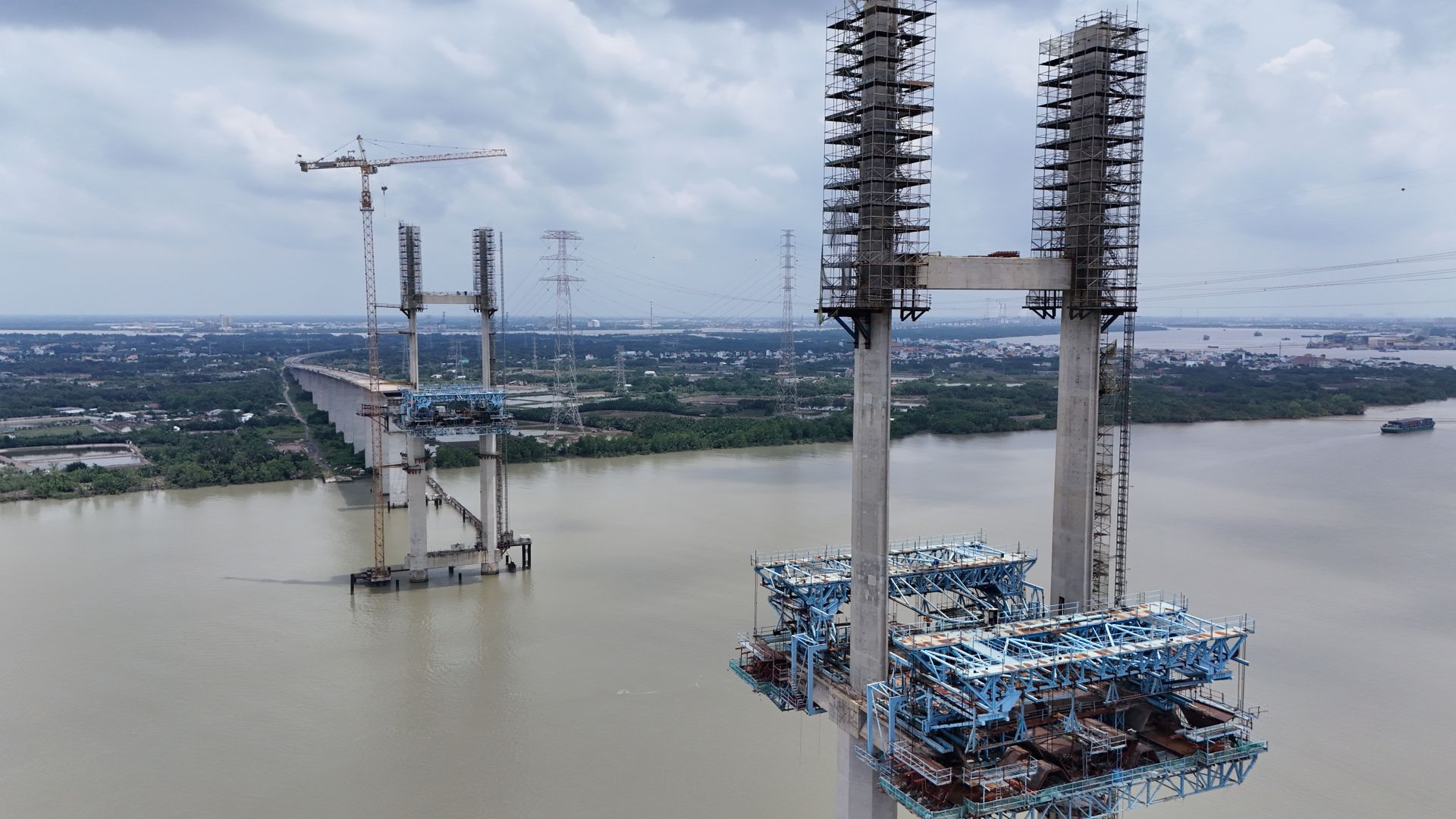 Aerial photo of a bridge under construction over a river in Vietnam.