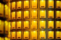 Luminous display of gold bars in a secure vault setting, glowing with golden light.