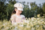 Girl Standing on White-petaled Flower Field