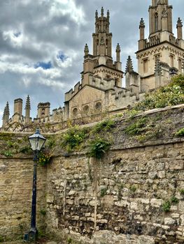 A captivating view of Oxford University's iconic Gothic architecture with cloudy sky backdrop.
