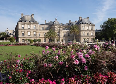 Beautiful view of Luxembourg Palace and its vibrant gardens in Paris, showcasing historic architecture and blooming flowers.