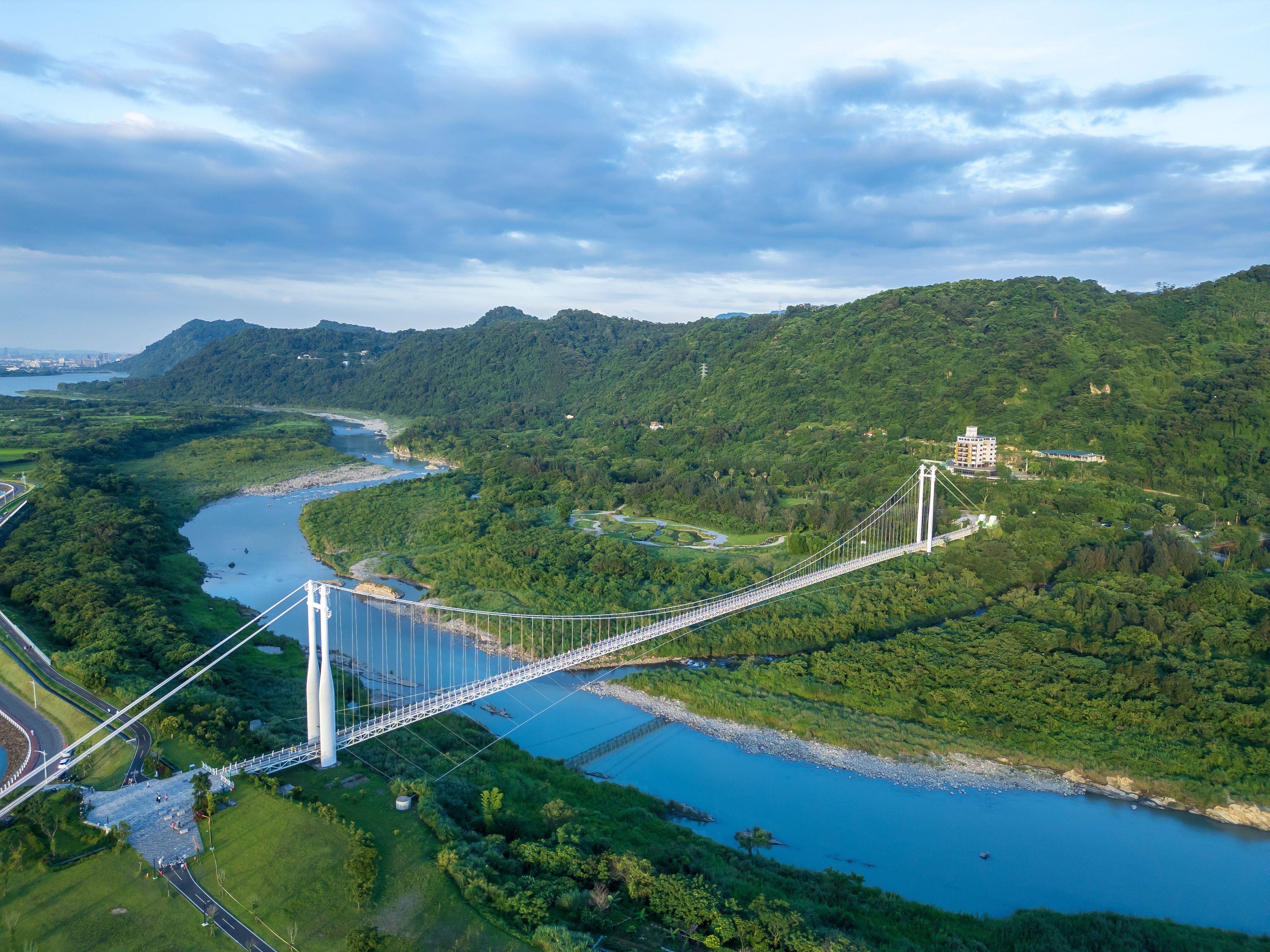 Majestic Cable Bridge Over Verdant Landscape · Free Stock Photo
