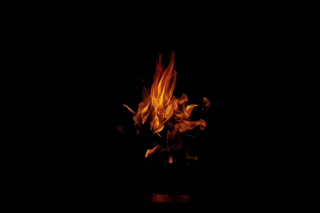bright orange flames creating an artistic display in the dark highligh