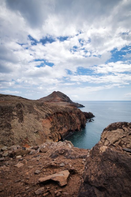 Free Stunning coastal cliff scene with dynamic clouds and vast ocean horizon. Stock Photo