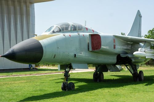 Free A historic military fighter jet displayed outside on a sunny day, perfect for aviation enthusiasts. Stock Photo