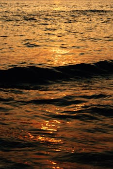 A mesmerizing golden sunset reflected on ocean waves, captured in El Salvador.