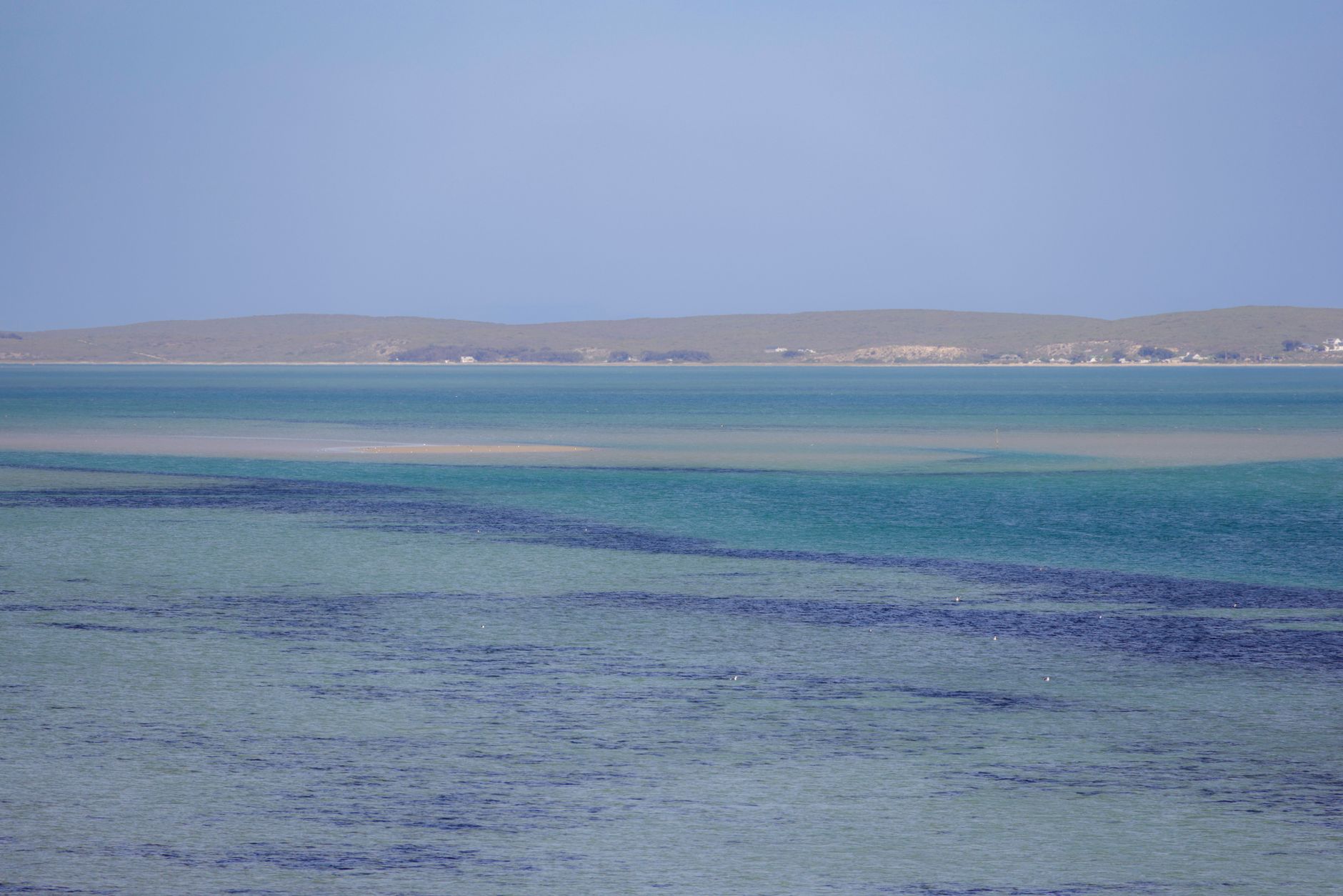 A tranquil seascape with azure waters and a serene horizon, ideal for relaxation themes.