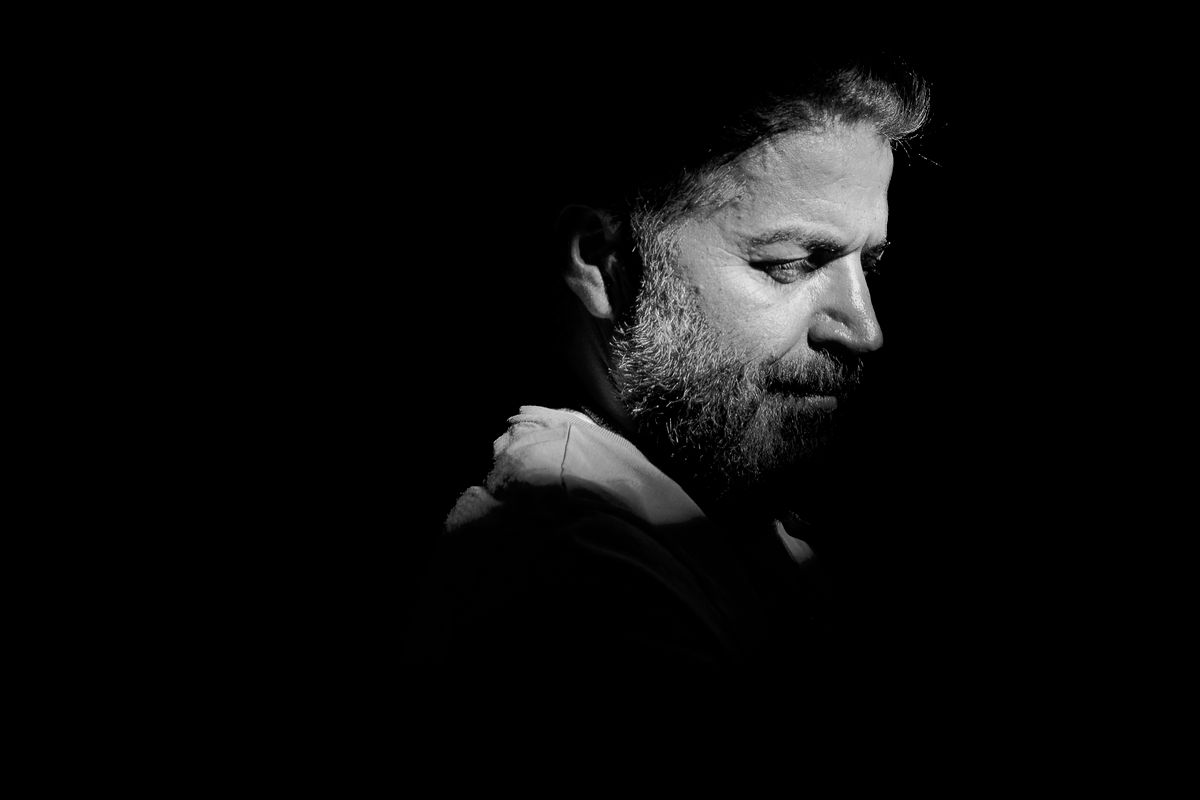 Bearded man in profile lit against a black field. Photo by HAMZA YILDIZ on Pexels