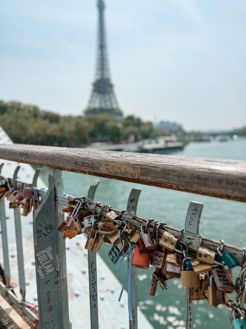 Free Love locks on a Paris bridge rail with the Eiffel Tower in the background, symbolizing romance. Stock Photo