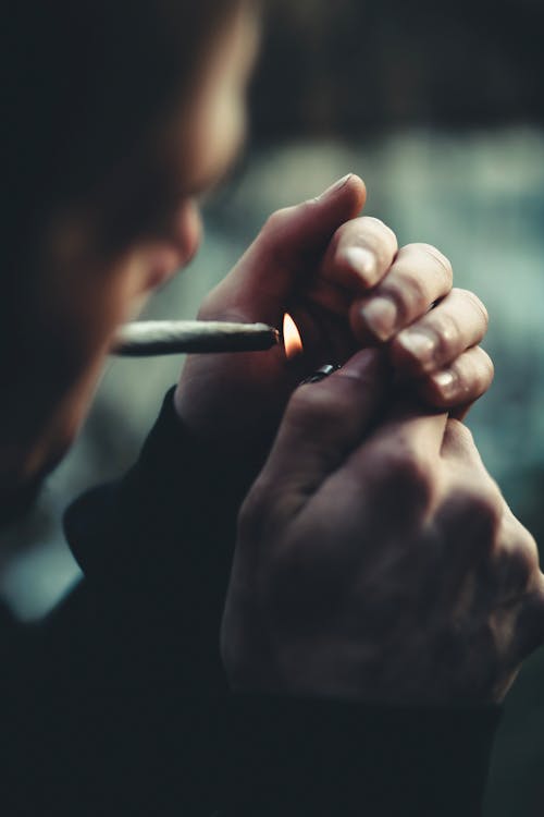 Free Selective Focus Photography of Man Lighting Cigarette Stock Photo