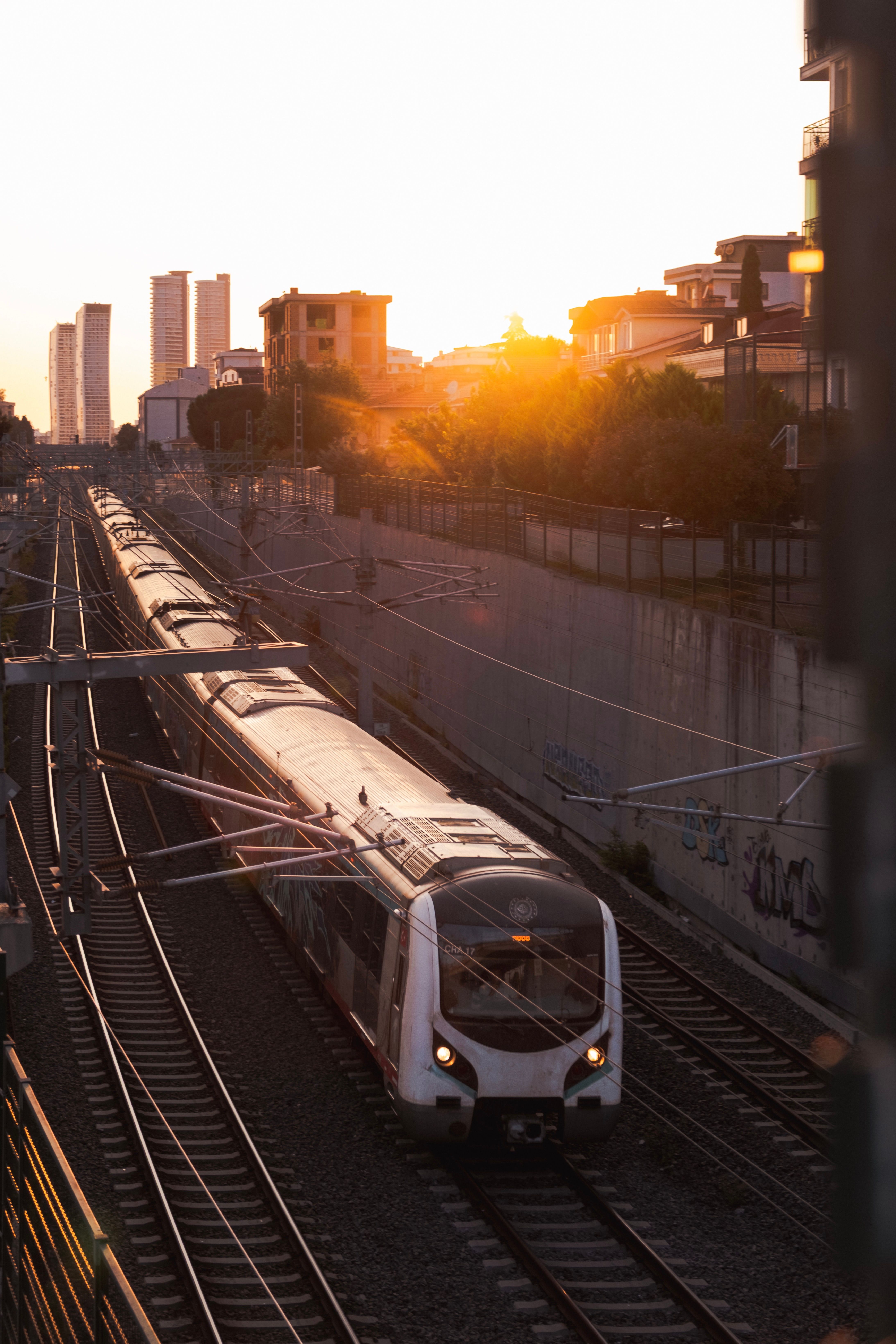 Urban Commuter Train at Sunset in Cityscape · Free Stock Photo