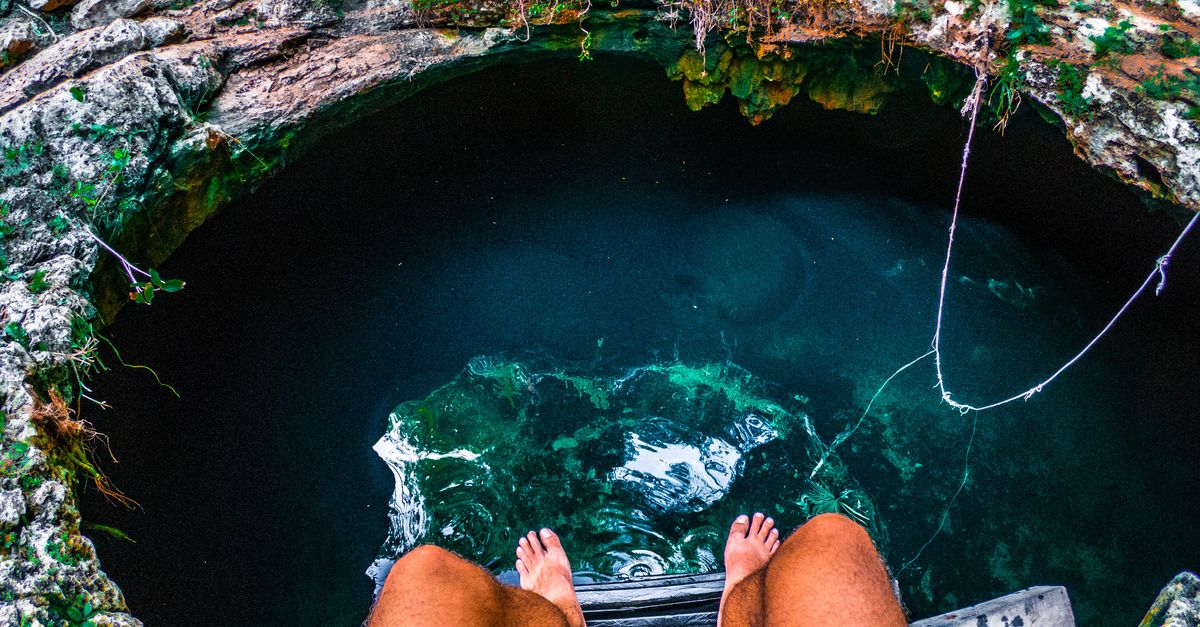 An exhilarating view from above a cenote in Tulum, Mexico, a perfect spot for an adventurous summer dive.