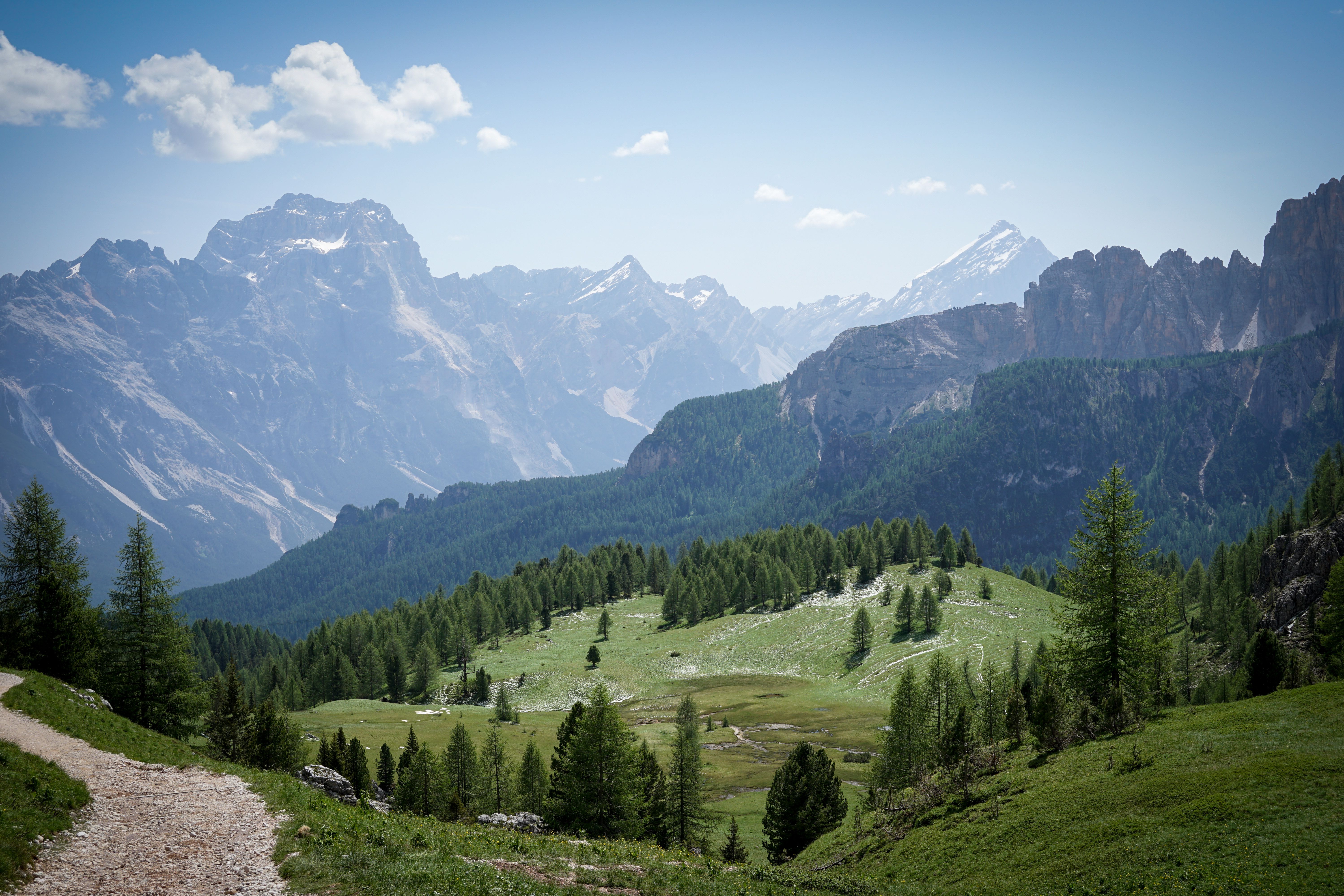 Green Grass Field Near Mountain Under Gray and White Sky at Day · Free ...