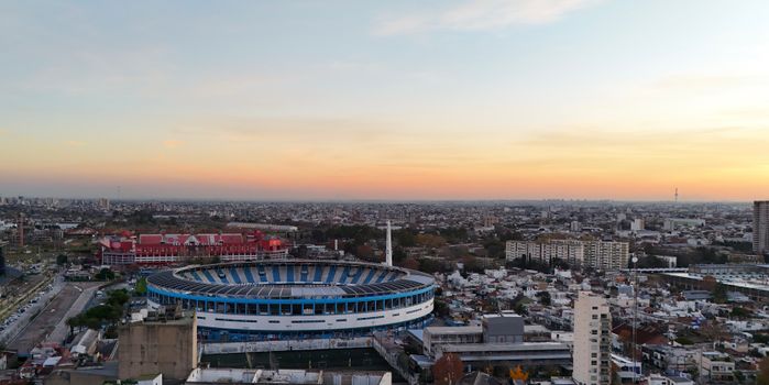 Stunning aerial view of Avellaneda with a focus on the prominent local stadium during sunset.