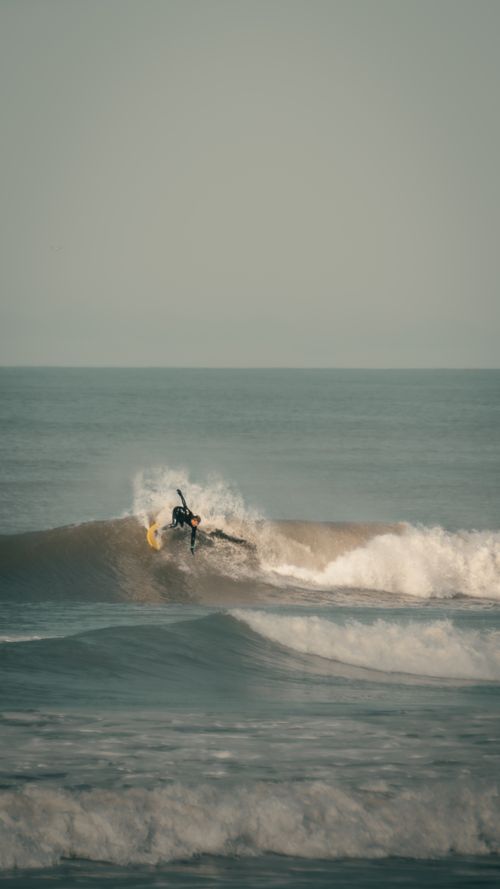 Free A surfer skillfully rides a wave in Mar del Plata's serene ocean setting. Stock Photo