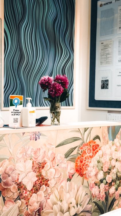 Floral Reception Desk with Vibrant Wall Art · Free Stock Photo