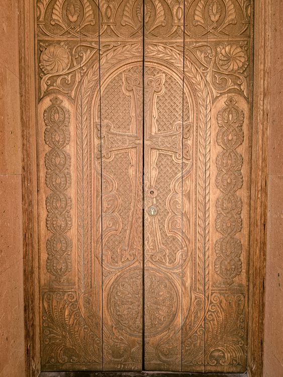 Ornately Carved Wooden Door with Cross Motif · Free Stock Photo