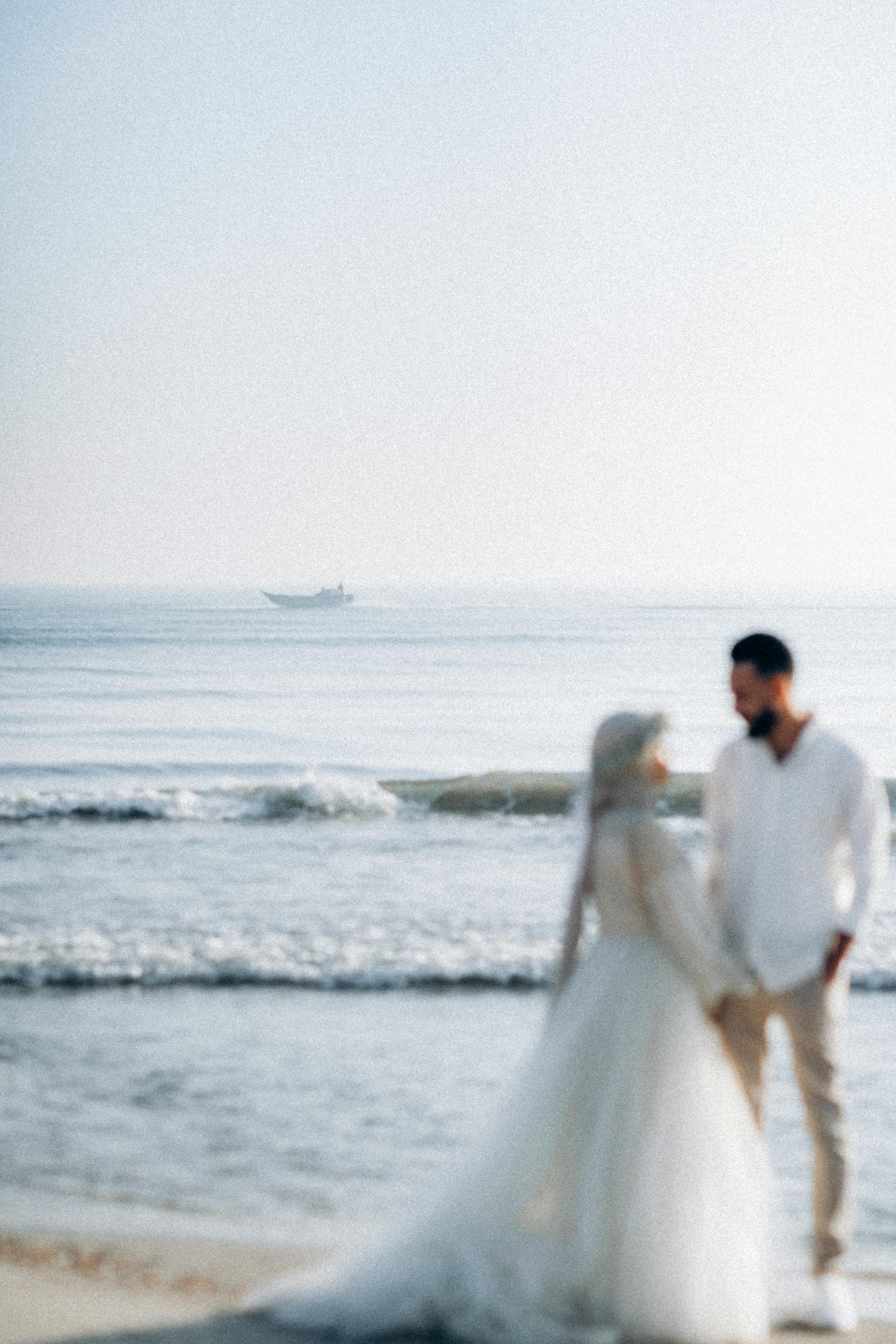 A couple shares a romantic moment on a serene Egyptian beach, perfect for wedding photography.