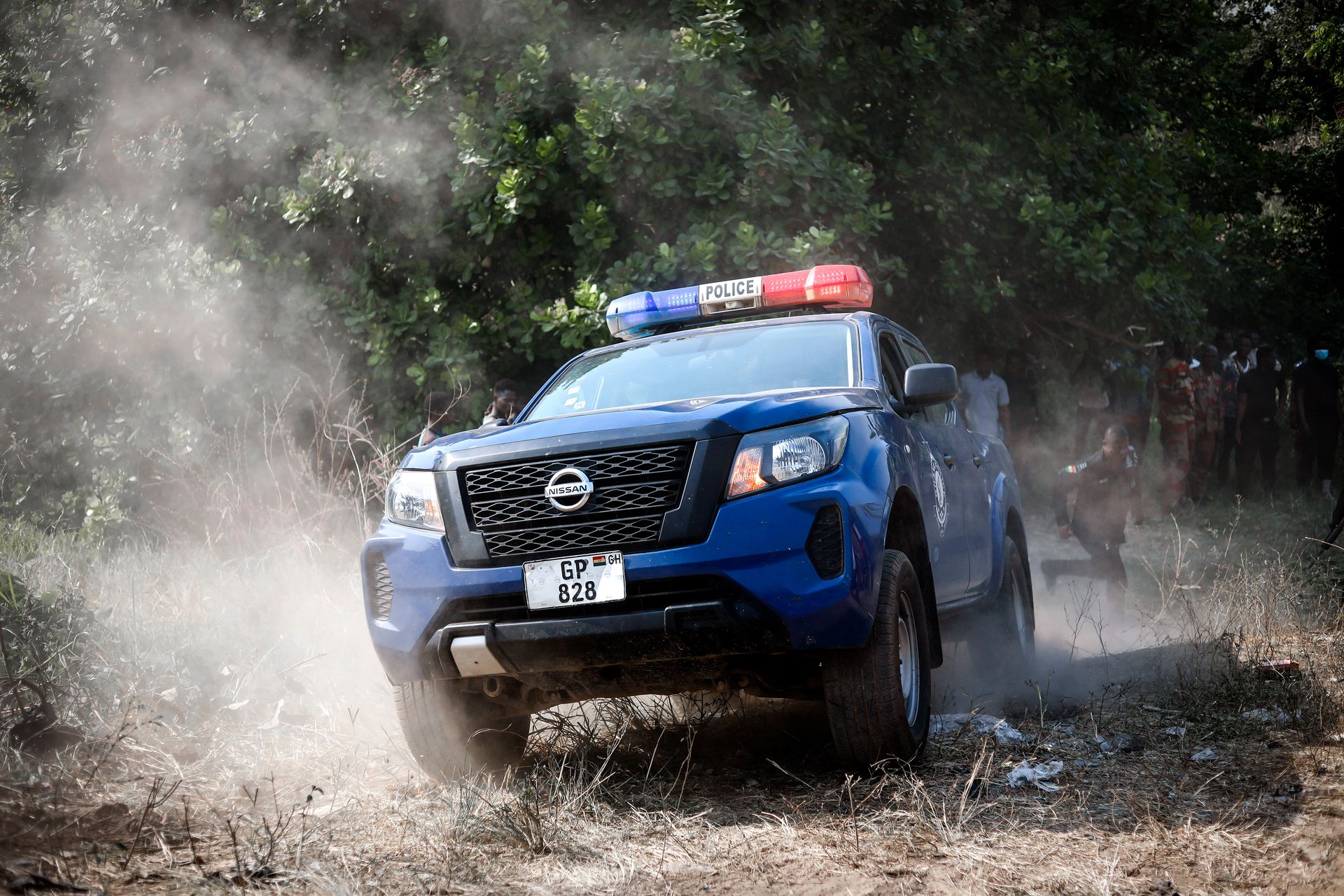 A police vehicle navigates offroad terrain in Kintampo, Ghana, showcasing law enforcement readiness.