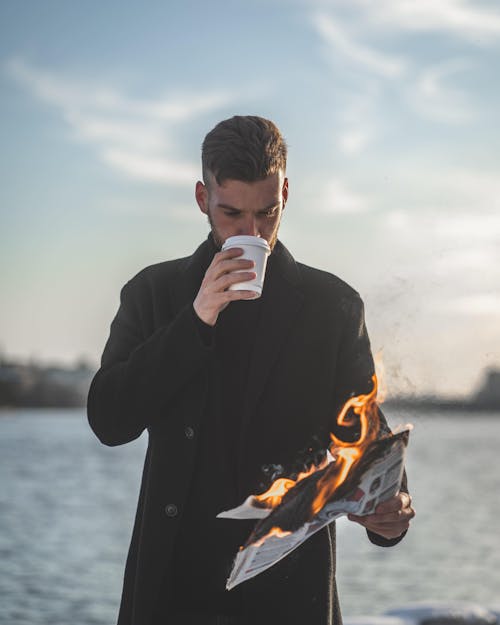 Free Man Holding Burning Paper Stock Photo
