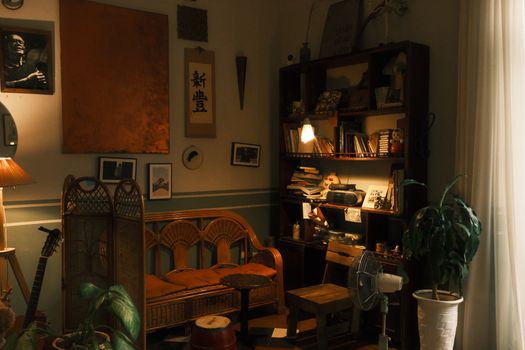 Warm and inviting vintage reading room with bookshelves and natural lighting.