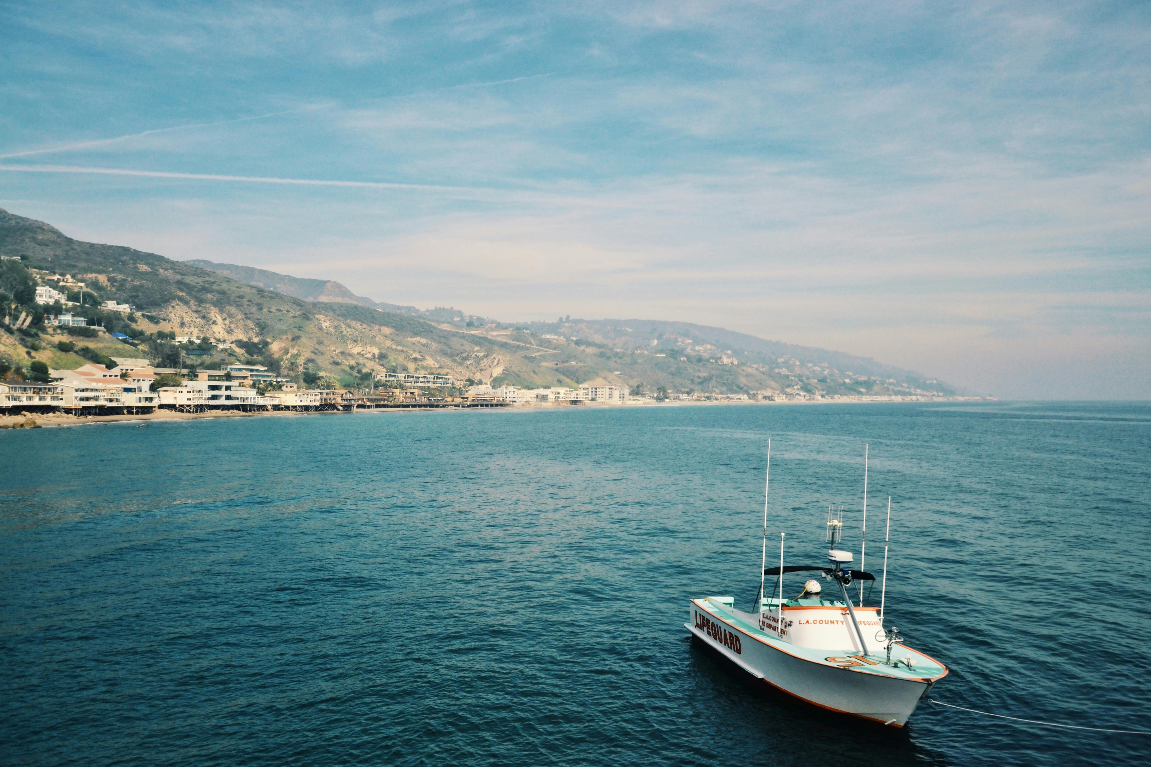 Man sailing a Malibu boat on sunny water
