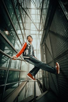 Stylish urban portrait of a young man in a modern architectural setting.