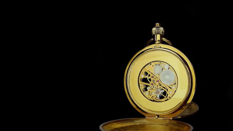 Close-up Of Pocket Watch Gears Against Black Background