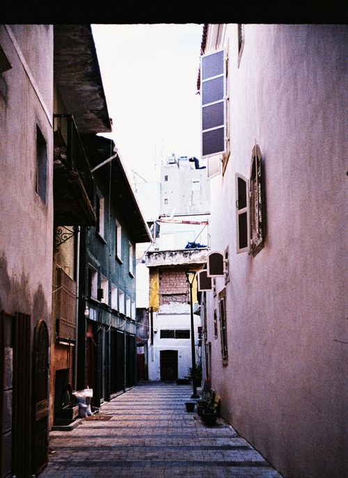 Free Explore the charm of a historic alleyway in İzmir, showcasing classic architecture and serene ambiance. Stock Photo