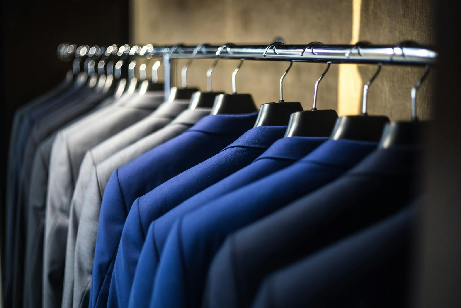 A row of suits neatly organized.
