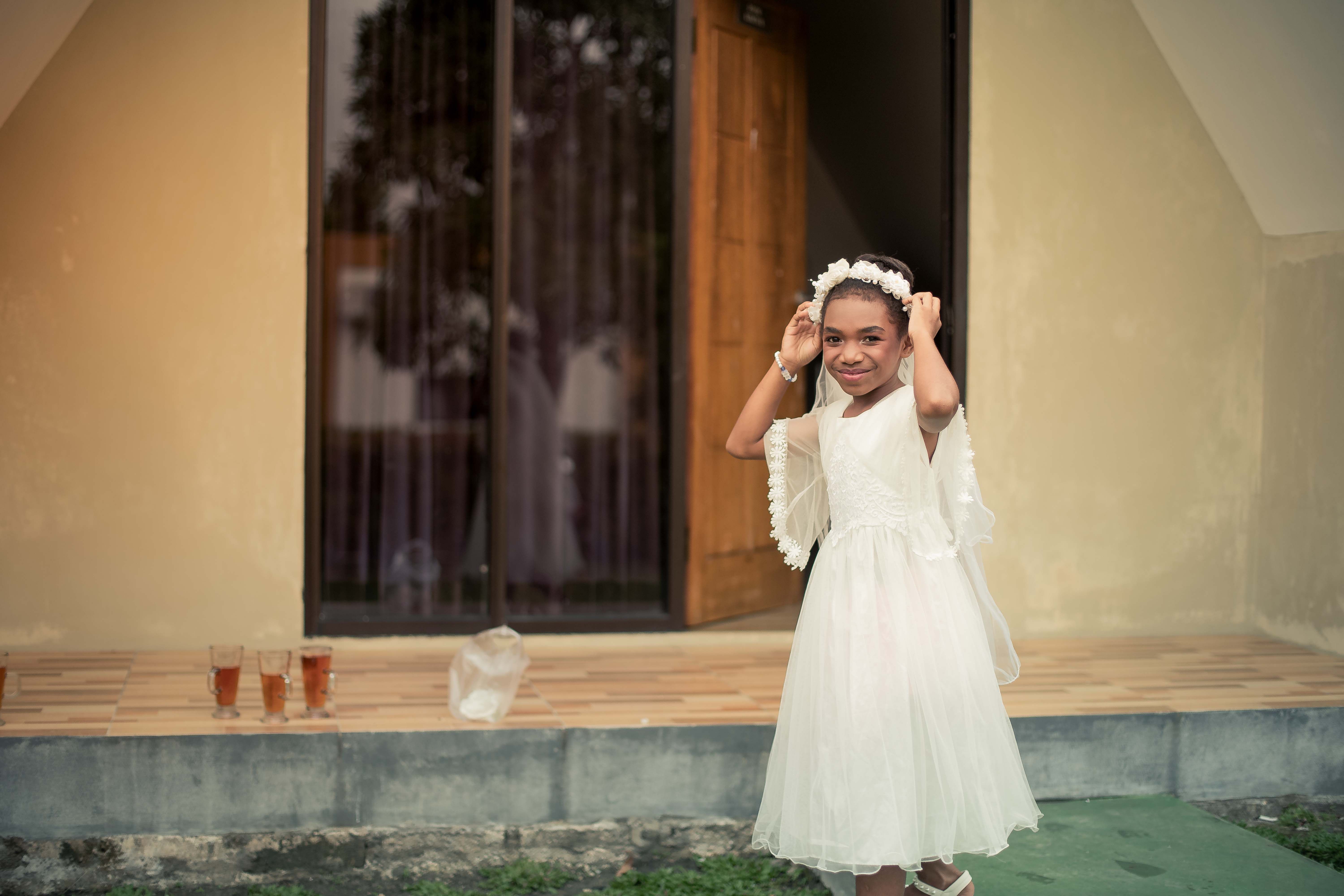 Young Girl in White Dress Smiling Outdoors · Free Stock Photo