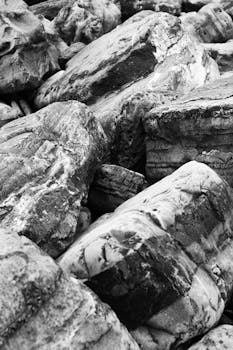 Explore the rugged textures of rocks in Hendaye, France, captured in black and white.