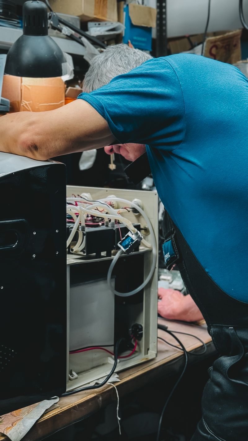 Technician inspecting a range hood fan motor