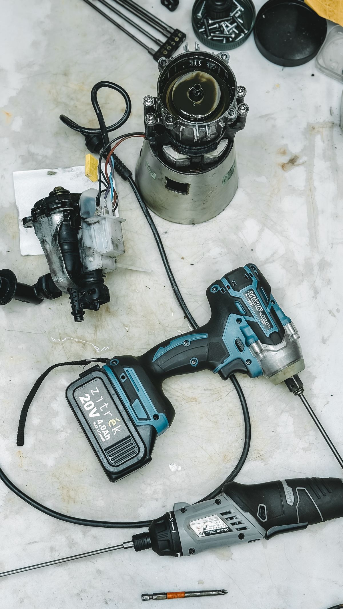 Disassembled appliance parts on a workbench for a repair versus replace guide