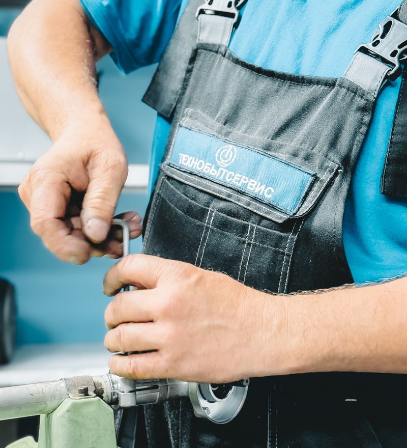 A 24/6 technician working on a repair with a wrench