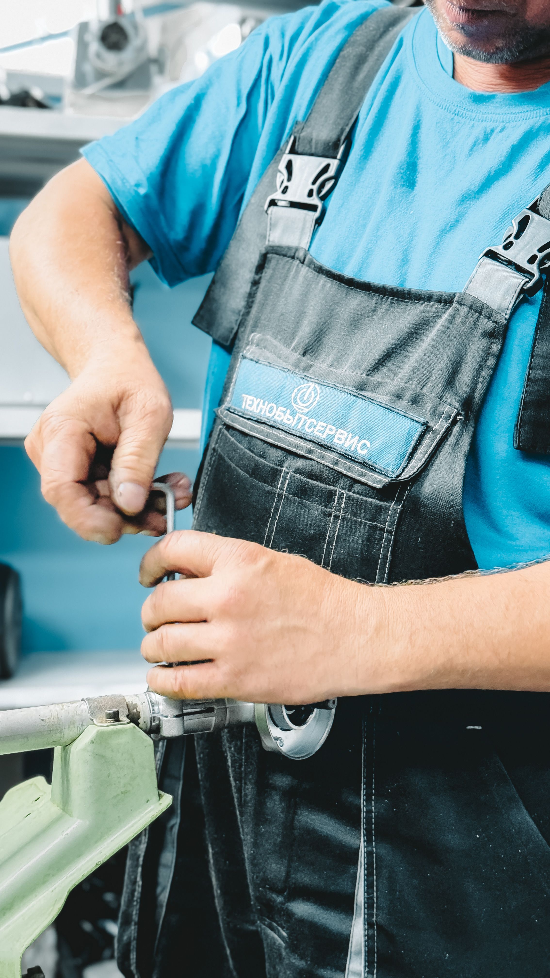 Plumber repairing a pipe with a wrench after a sewer camera inspection in Dallas
