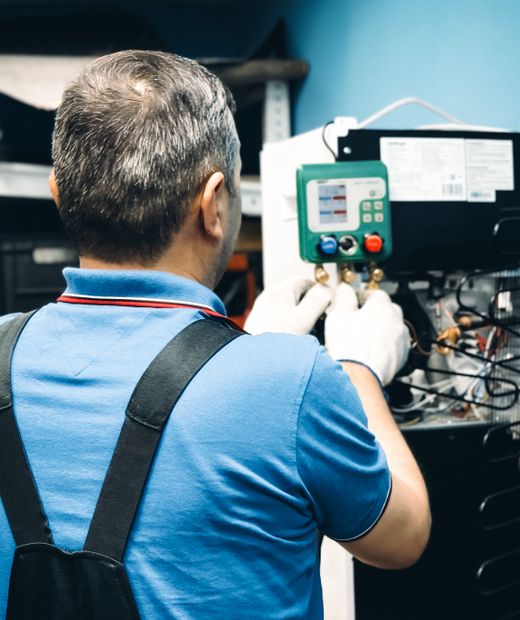 Technician working on an HVAC system indoors